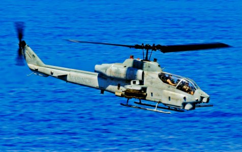 US Navy 090609-N-5345W-008 An AH-1W Super Cobra from the Thunder Chickens of Marine Medium Tiltrotor Squadron (VMM) 263 performs a low-altitude surveillance pass during a Visit, Board, Search and Seizure (VBSS) drill
