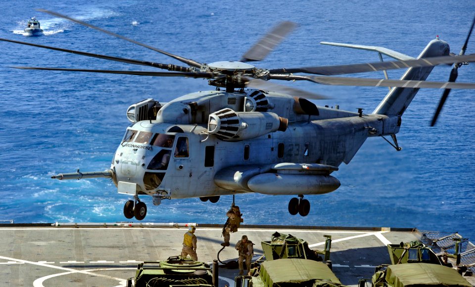US Navy 090609-N-5345W-029 Marines assigned to the 22nd Marine Expeditionary Unit (MEU) fast rope from a CH-53 Super Stallion to the flight deck of the amphibious dock landing ship USS Fort McHenry (LSD 43)