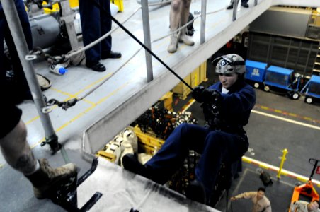 US Navy 090610-N-2344B-030 Midshipman Veronica Bildzukowicz prepares to push off a platform during a fast-roping exercise in the hangar bay of the aircraft carrier USS Ronald Reagan (CVN 76)