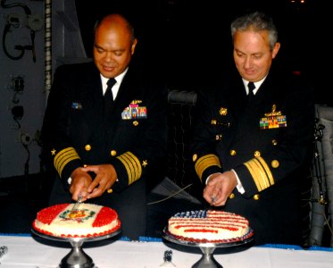 US Navy 090611-N-4879G-197 Commander of Destroyer Squadron (DESRON) 40 Capt. Rodelio Laco and Vicealmirante Carlos Chanduvi Salazar cut cakes during a reception aboard the guided missile frigate USS Doyle (FFG 39)