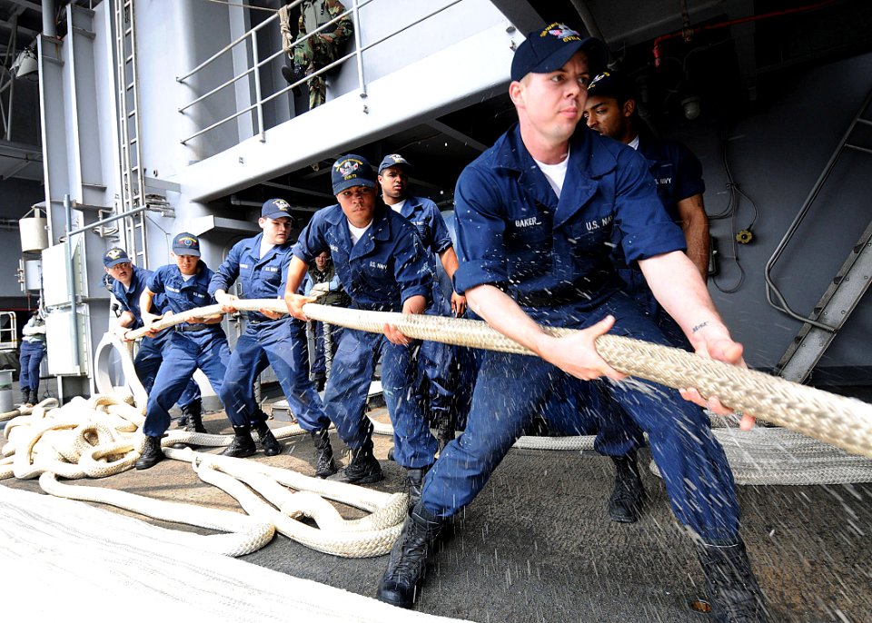 US Navy 090610-N-1062H-044 Sailors pull in a mooring line aboard the aircraft carrier USS George Washington (CVN 73) in preparation for the ship's first summer deployment since arriving at Fleet Activities Yokosuka, Japan
