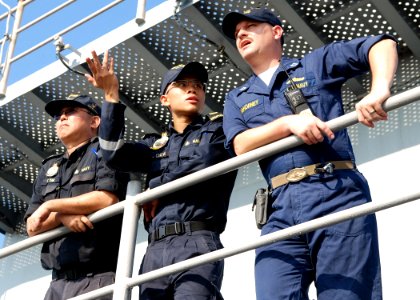US Navy 090611-N-5207L-003 Republic of Singapore Navy Warrant Officers K.C. Tan, left, and Lt. C.H. Chew discuss flight deck operations