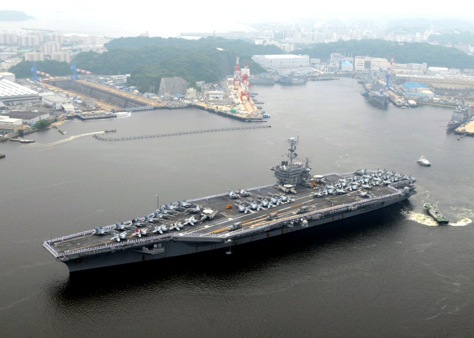 US Navy 090610-N-9565D-019 Sailors man the rails aboard the aircraft carrier USS George Washington (CVN 73) as the ship departs on her first summer deployment since arriving at Fleet Activities Yokosuka, Japan