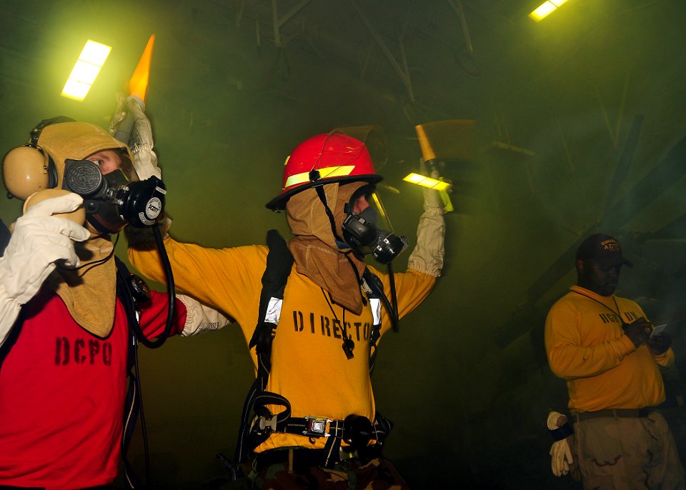 US Navy 090611-N-6233C-038 Sailors aboard the aircraft carrier USS George Washington (CVN 73) participate in a general quarters drill in the ship's hangar bay