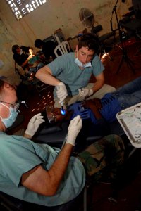 US Navy 090612-F-1333S-042 A Colombian boy receives dental care from medical providers deployed with the Miitary Sealift Command hospital ship USNS Comfort (T-AH 20) during a Continuing Promise 2009 medical civic action program photo