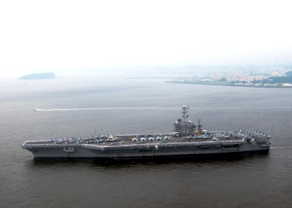 US Navy 090610-N-9565D-086 Sailors man the rails aboard the aircraft carrier USS George Washington (CVN 73) as the ship departs on her first summer deployment since arriving at Fleet Activities Yokosuka, Japan