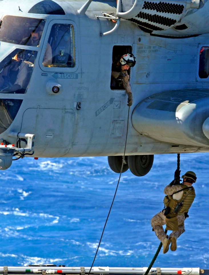 US Navy 090609-N-5345W-125 A Marine from the 22nd Marine Expeditionary Unit (MEU) Visit, Board, Search and Seizure (VBSS) team aboard USS Bataan (LHD 5) fast ropes from a CH-53 Super Stallion