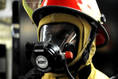 US Navy 090611-N-5242D-248 Djiboutian Navy Cpl. Abdoullauder Issa tests a full fire-fighting ensemble and MCU-2P gas mask after receiving damage control familiarization training photo