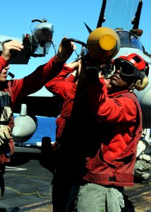 US Navy 090612-N-8534H-185 Aviation Ordnanceman 3rd Class Jamel Bell, assigned to the Golden Dragons of Strike Fighter Squadron (VFA) 192, helps offload an AIM-9 sidewinder missile