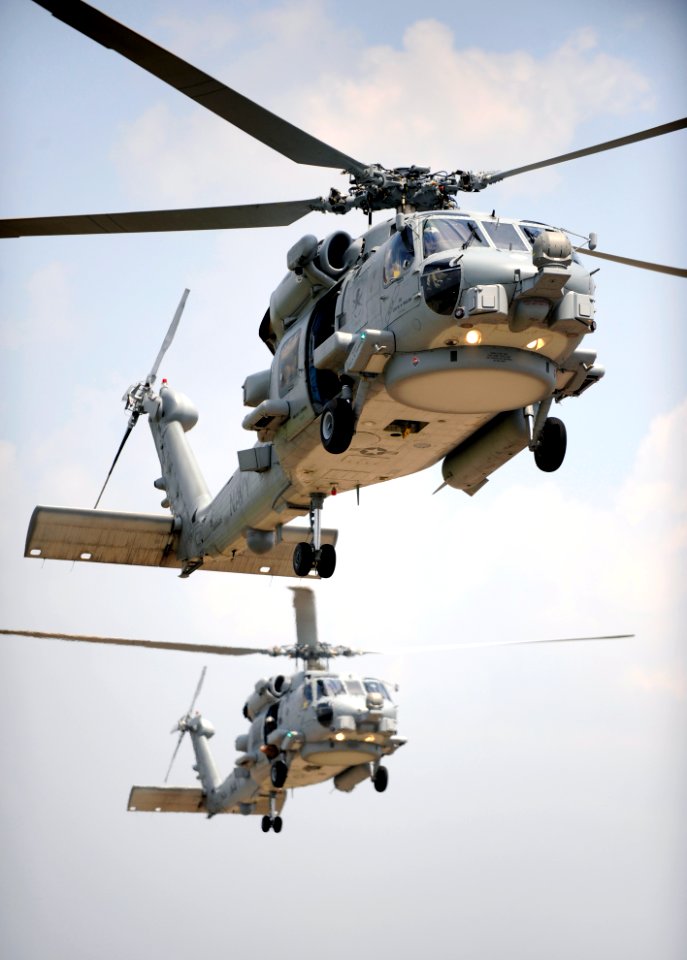 US Navy 090610-N-0413R-153 Two multi-mission MH-60R Sea Hawk helicopters fly in tandem during section landings at Naval Air Station Jacksonville, Fla