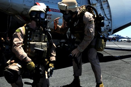US Navy 090612-N-3659B-040 Members of Explosive Ordnance Disposal Mobile Unit (EODMU) 11, Platoon 0-2, conduct an equipment check prior to the start of a fast-roping exercise photo