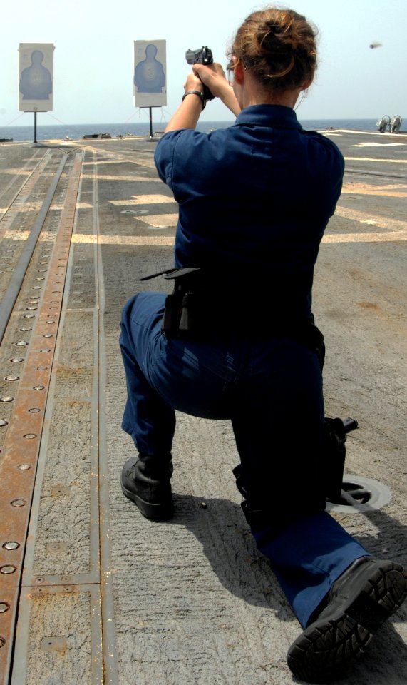 US Navy 090613-N-6639M-136 Boatswain's Mate Seaman Recruit Leslie Ramer fires a pistol during a live-fire exercise aboard the guided-missile destroyer USS James E. Williams (DDG 95)