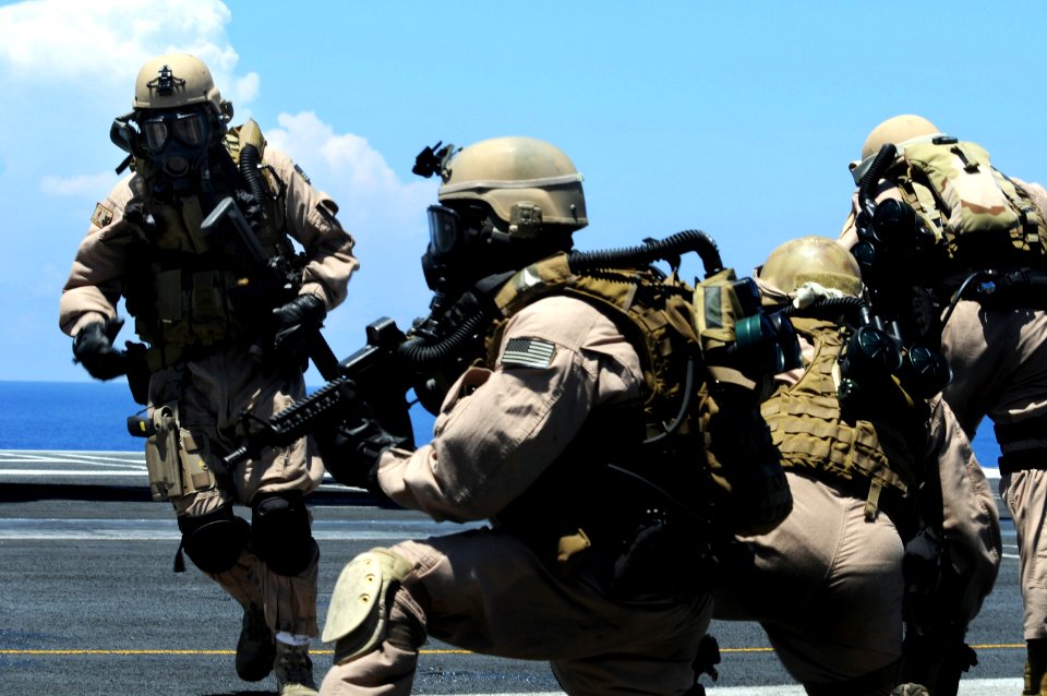 US Navy 090612-N-3659B-122 Members of Explosive Ordnance Disposal Mobile Unit (EODMU) 11, Platoon 0-2, take their positions on the flight deck of the aircraft carrier USS Ronald Reagan (CVN 76) during a fast-roping exercise