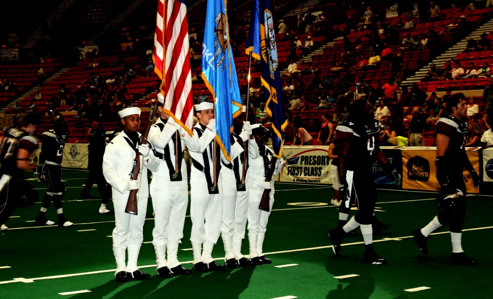 US Navy 090613-N-3750S-492 Members of the Navy Color Guard join the Oklahoma City Yard Dawgz players on the field at Cox Convention Center during the opening ceremony