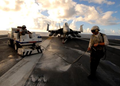 US Navy 090613-N-6720T-040 Aviation Machinist Mate Airman Jeremy Fortaleza, left, and Aviation Support Equipment Technician Airman John Sexton pressure wash the flight deck of the aircraft carrier USS George Washington (CVN73)