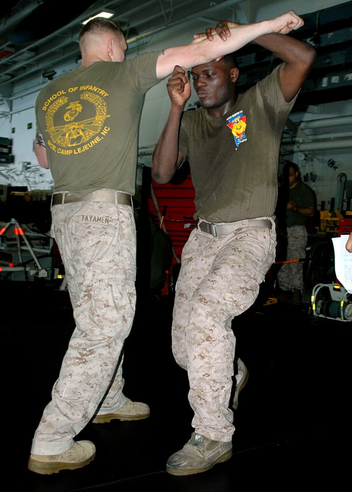 US Navy 090613-N-6410J-045 Cpl. Mark Tayamen and Lance Cpl. Franklin Simmons, assigned to 13th Marine Expeditionary Unit Marines, embarked aboard amphibious assault ship USS Boxer (LHD 4), practice hand-to-hand combat skills