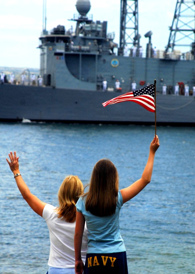 US Navy 090615-N-8539M-098 Family members of Sailors aboard the Oliver Hazard Perry class guided-missile frigate USS Crommelin (FFG 37) wave good-bye as the ship departs Naval Station Pearl Harbor for a scheduled six-month depl