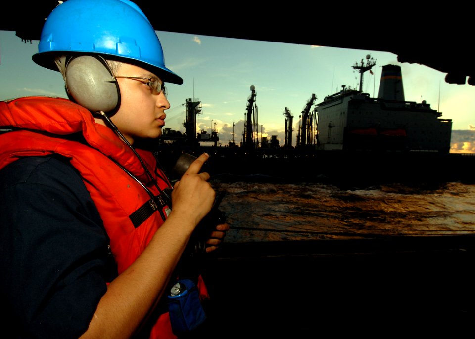 US Navy 090613-N-7282P-096 Seaman Richie Zapata, assigned to the deck department of the aircraft carrier USS George Washington (CVN 73) operates a sound powered phone to communicate with the navigation bridge