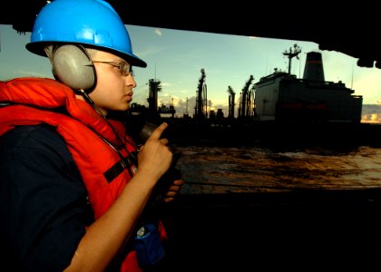 US Navy 090613-N-7282P-096 Seaman Richie Zapata, assigned to the deck department of the aircraft carrier USS George Washington (CVN 73) operates a sound powered phone to communicate with the navigation bridge
