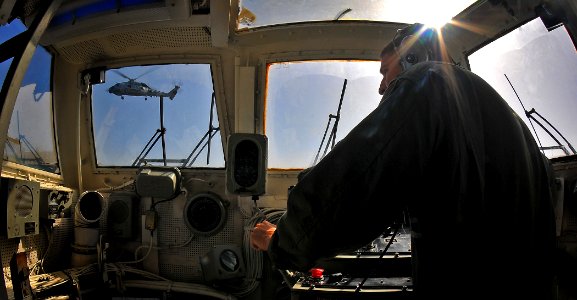 US Navy 090613-N-4774B-019 Lt. Joseph Jindrich observes an SH-60B helicopter, assigned to the Helicopter Squadron Light (HSL) 45 take off from the guided-missile cruiser USS Lake Champlain (CG 57)