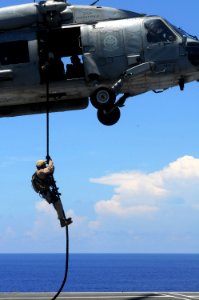US Navy 090612-N-3659B-187 An explosive ordnance disposal (EOD) technician assigned to Explosive Ordnance Disposal Mobile Unit (EODMU) 11, Platoon 0-2, fast ropes onto the flight deck