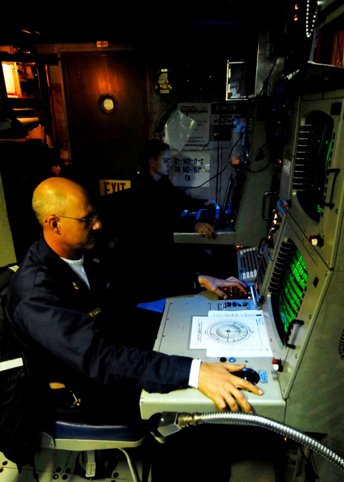 US Navy 090616-N-7092S-031 Senior Chief Sonar Technician Surface Anthony Beggs, left, and STG3 Joshua Colantuano monitor data from the tactical towed array sonar aboard the guided-missile frigate USS Kauffman (FFG 59)