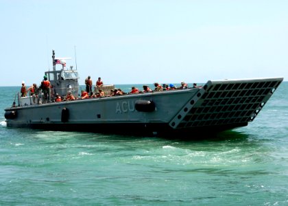 US Navy 090615-N-6676S-456 Landing Craft Mechanized (LCM) 14, assigned to Assault Craft Unit (ACU) 2, transports Sailors, Soldiers and Marines during operations supporting Joint Logistics Over-The-Shore (JLOTS) exercises