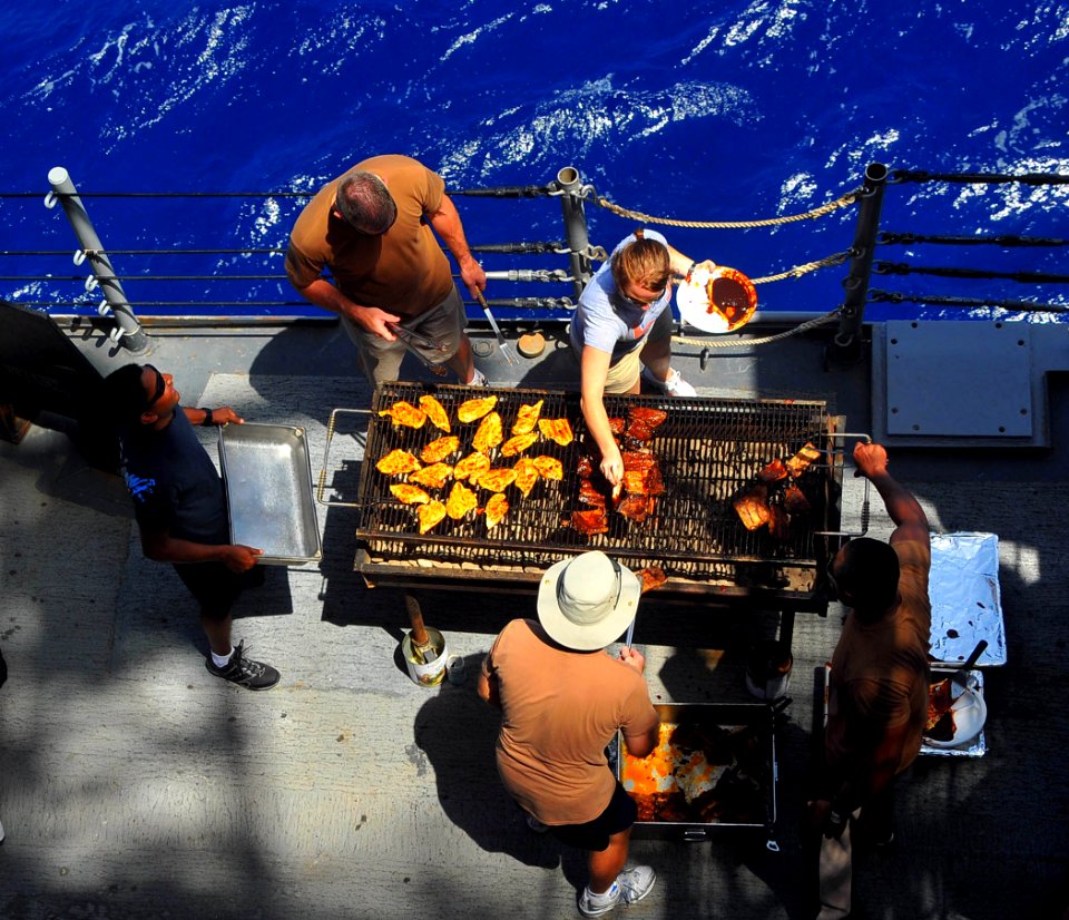 US Navy 090614-N-4774B-017 ailors assigned to the Expeditionary Resuscitative Surgical System (ERSS) mobile medical team prepare lunch aboard the guided-missile cruiser USS Lake Champlain (CG 57) during a Steel Beach Picnic
