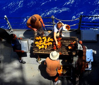 US Navy 090614-N-4774B-017 ailors assigned to the Expeditionary Resuscitative Surgical System (ERSS) mobile medical team prepare lunch aboard the guided-missile cruiser USS Lake Champlain (CG 57) during a Steel Beach Picnic
