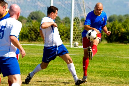 US Navy 090613-N-9552I-127 A player from Naval Air Station Sigonella kicks the ball downfield during a soccer game against the Italian Air Force 41st Stormo.