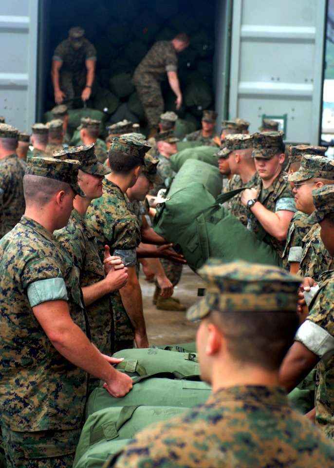 US Navy 090615-N-9950J-127 Marines assigned to the 31st Marine Expeditionary Unit (MEU) unload sea bags on the pier before embarking aboard the forward-deployed amphibious assault ship USS Essex (LHD 2)