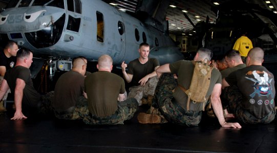 US Navy 090613-N-6410J-059 Sgt. Keith Pulley, a 13th Marine Expeditionary Unit Marine Corps Martial Arts Program (MCMAP) instructor, embarked aboard amphibious assault ship USS Boxer (LHD 4), talks to MCMAP students in the han photo