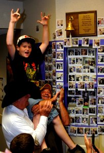 US Navy 090616-N-3750S-195 Taylor Phillips celebrates after ringing the Navy ship's bell signaling his release from treatment at the Jimmy Everest Center for Cancer and Blood Disorders in Children