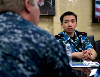 US Navy 090614-F-7923S-006 Capt. James J. Ware, left, commanding officer of the medical treatment facility aboard the Military Sealift Command hospital ship USNS Comfort (T-AH 20), speaks with a group of Chinese medical observe