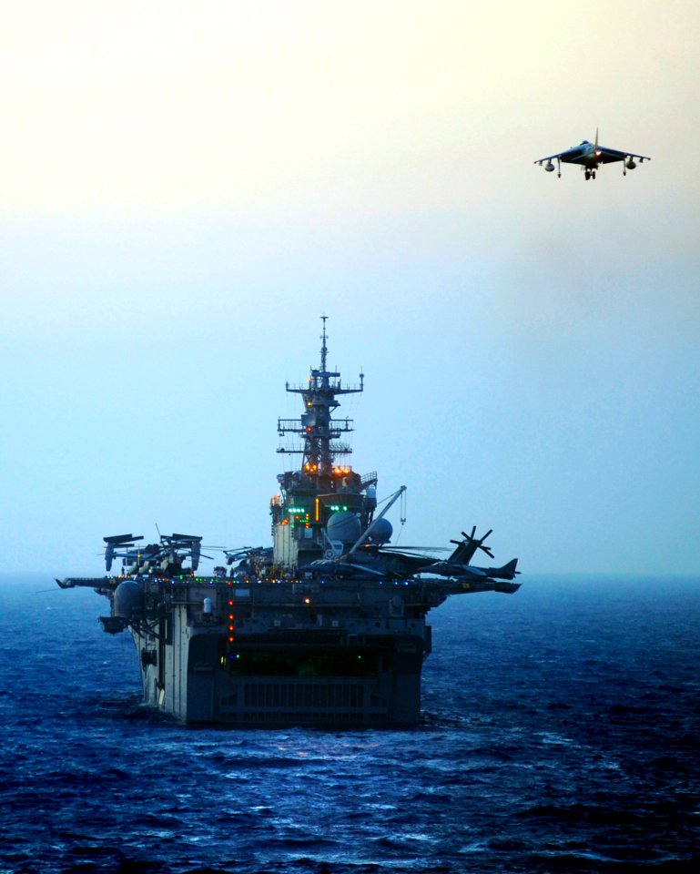 US Navy 090618-N-5345W-051 An AV-8B Harrier lands aboard the amphibious assault ship USS Bataan (LHD 5) during evening flight operations