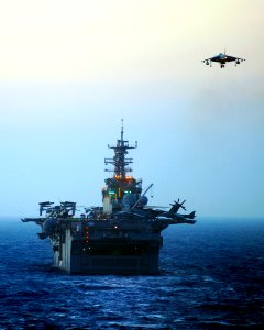 US Navy 090618-N-5345W-051 An AV-8B Harrier lands aboard the amphibious assault ship USS Bataan (LHD 5) during evening flight operations