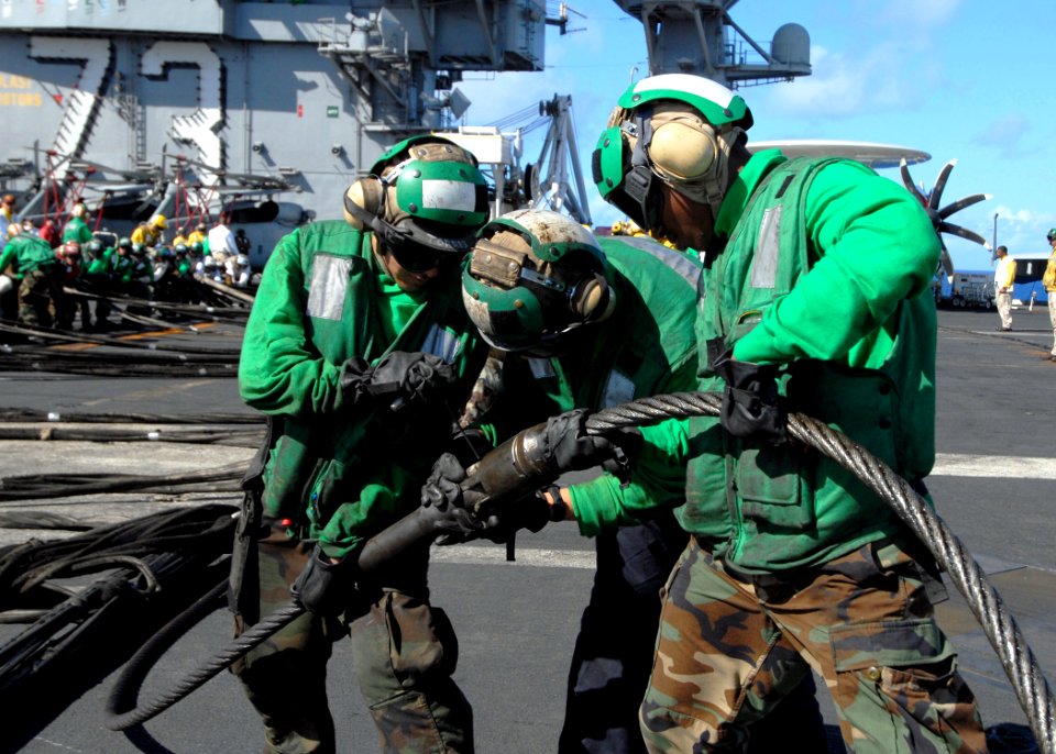 US Navy 090618-N-6720T-065 Sailors assigned to the air department aboard the aircraft carrier USS George Washington (CVN 73) prepare to raise a Ready-Jet aircraft barricade during a general quarters drill