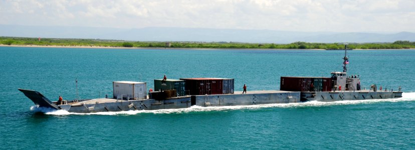 US Navy 090617-N-0577G-074 A floating causeway transports cargo containers from the Military Sealift Command crane ship SS Cornhusker State (T-ACS 6) to the shore of U.S. Naval Station Guantanamo Bay