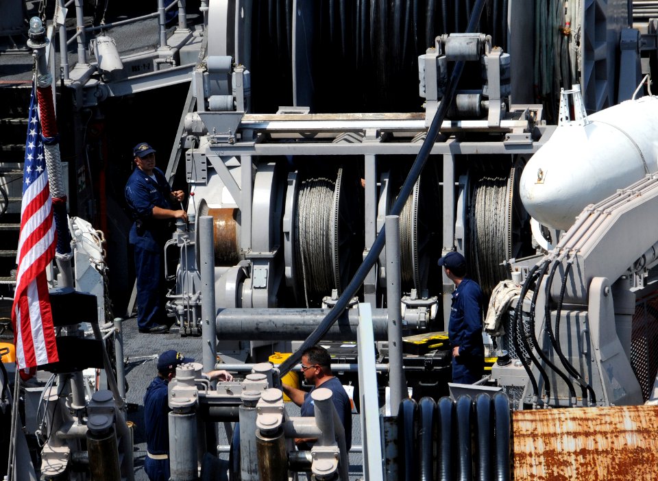 US Navy 090617-N-0807W-021 Sailors assigned to the Avenger-class mine countermeasures ship USS Patriot (MCM 7) reel in an electromagnetic mine sweep cable