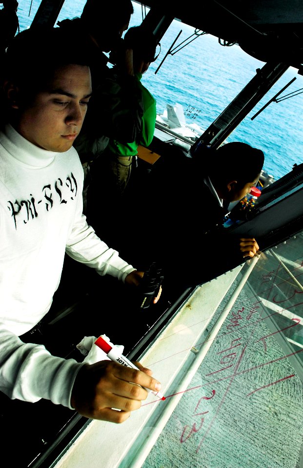 US Navy 090618-N-9928E-039 Aviation Boatswain's Mate (Fuels) Airman Aaron Morales, from Santa Ana, Calif., logs aircraft launches and recoveries in primary flight control