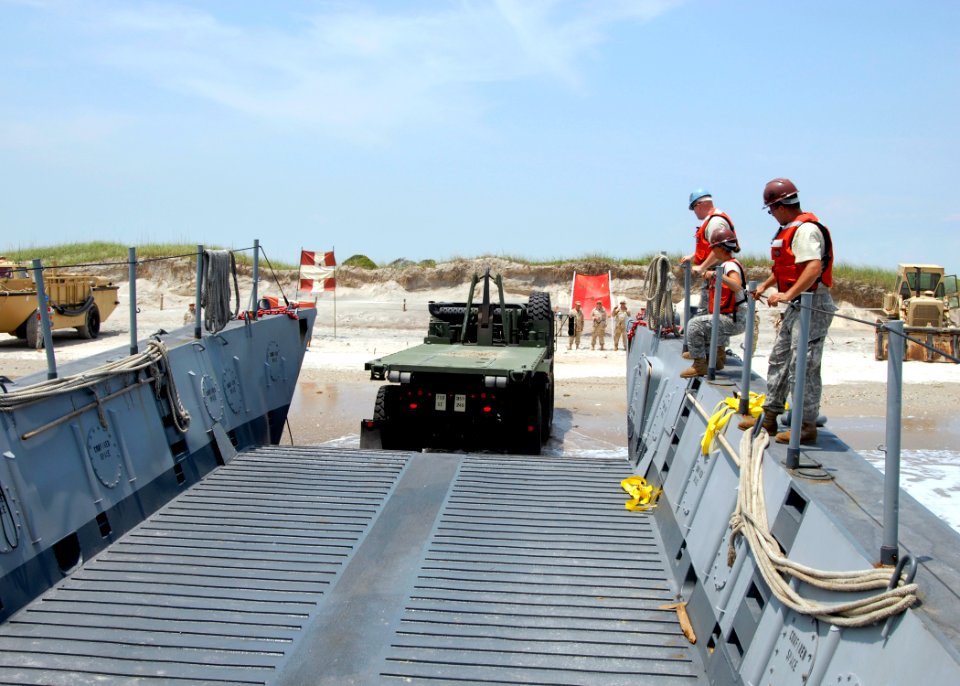 US Navy 090615-N-6676S-396 A load handling system cargo truck is driven off a landing craft mechanized (LCM) onto Onslow Beach during Joint Logistics Over-the-Shore (JLOTS) operations