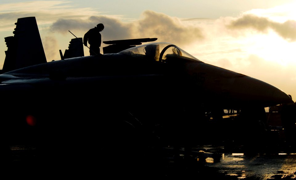 US Navy 090619-N-6538W-125 Aviation Ordnanceman Airman Apprentice Garrett P. Hazelwood, from Corona, Calif., scrubs the wing of an F-A-18C Hornet