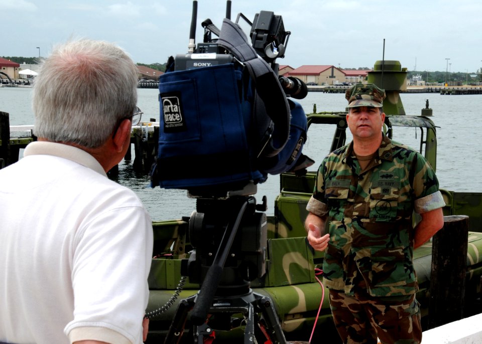 US Navy 090617-N-9095H-013 Capt. David Balk, special assistant to the commander of Navy Expeditionary Combat Command (NECC), speaks with local media in front of a riverine patrol boat