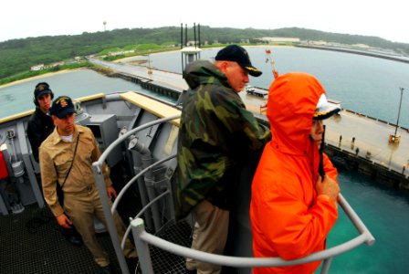 US Navy 090616-N-6692A-073 Capt. Mark Weber, center right, commanding officer of the amphibious dock landing ship USS Tortuga (LSD 46), overlooks the area as the ship pulls out from White Beach pier in Okinawa