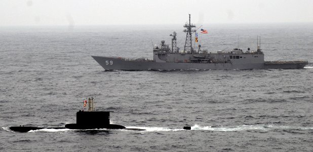 US Navy 090617-N-4879G-517 A surfaced Peruvian submarine is underway with the guided-missile frigate USS Kauffman (FFG 59) during a multi-national group sail involving the Peruvian and U.S. navies