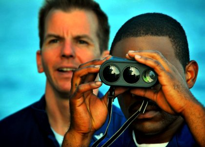 US Navy 090616-N-4774B-118 Quartermaster 1st Class Bradley Stevens provides instruction to Seaman Recruit Aaron Maultsby on the use of a laser range finder aboard the guided-missile cruiser USS Lake Champlain (CG 57)
