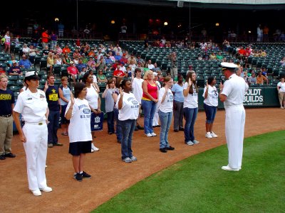 US Navy 090620-N-2888Q-031 Cmdr. Mike Mullins, right, commander, Navy Recruiting District Dallas, administers the Oath of Enlistment to 10 Delayed Entry Program members at the Bricktown Ballpark in Oklahoma City photo