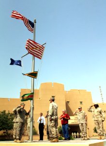 US Navy 090621-N-8053S-045 U.S. Navy and Marine Corps Aviation Ordnancemen stationed at Naval Support Activity Bahrain render a hand salute to the U.S. flag as it is raised in tribute to Medal of Honor recipient Lt. John Finn