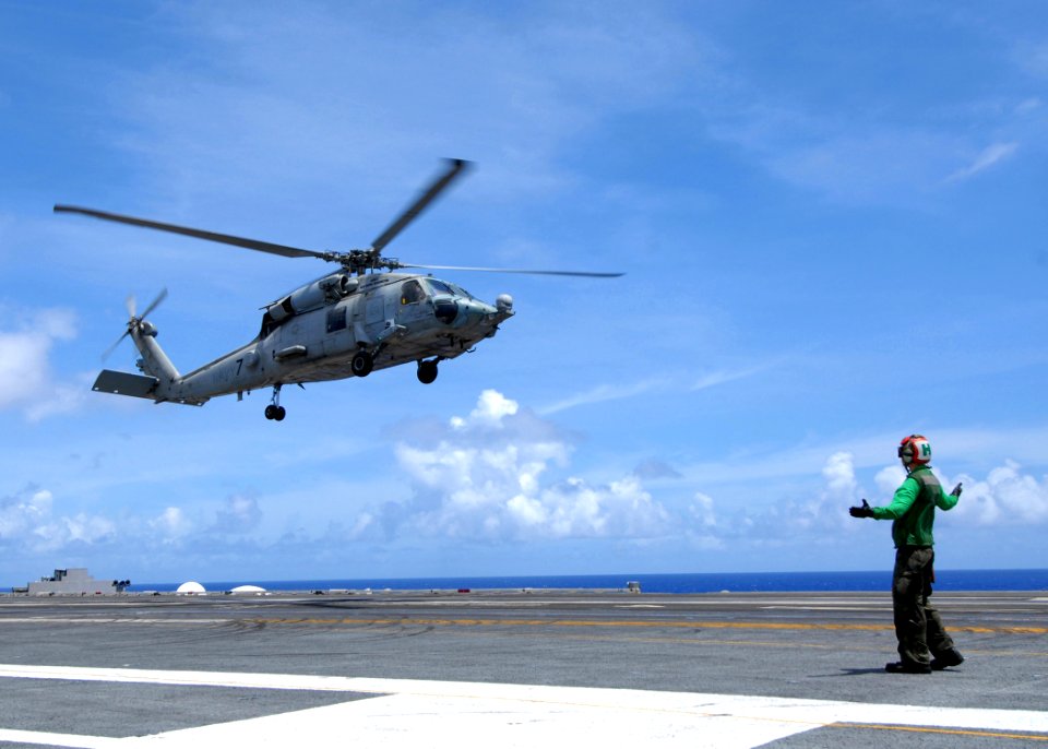 US Navy 090617-N-6720T-007 Aviation Structural Mechanic 2nd Class Patrick Maw signals to the pilot of an HH-60H Sea Hawk helicopter from the Chargers of Helicopter Anti-submarine Squadron (HS) 14 to lift-off