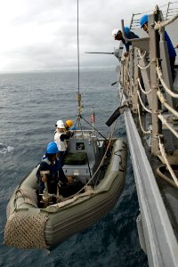 US Navy 090617-N-9123L-154 Sailors aboard the guided-missile destroyer USS McCampbell (DDG 85) recover a rigid hull inflatable boat after completing a personnel transfer off Okinawa, Japan photo